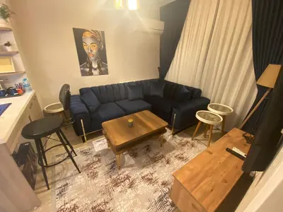 a living room with a blue couch and a table at Classic Suite MK1 in Istanbul