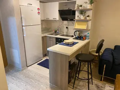 a small kitchen with a white refrigerator and a counter at Classic Suite MK1 in Istanbul