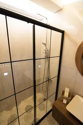 a shower with a glass door in a bathroom at Villa Nora Butik Otel ve Bungalov in Bursa