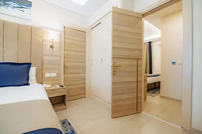 a small bedroom with a bed and a closet at The Milltown Hotel in Istanbul