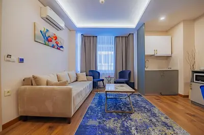 a living room with a couch and a kitchen at The Milltown Hotel in Istanbul