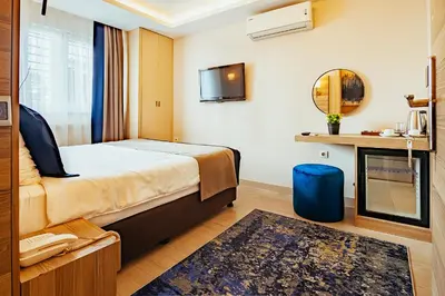 a hotel room with a bed and a mirror at The Milltown Hotel in Istanbul