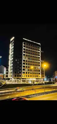 a large building with lights in front of a highway at Luxury Central Fully Equipped 2BR 2BA Apartment by Siena Suites in Istanbul