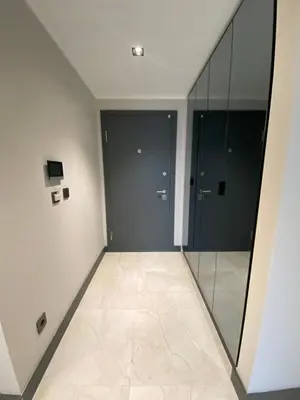 a hallway with glass doors and a tiled floor at Luxury Central Fully Equipped 2BR 2BA Apartment by Siena Suites in Istanbul