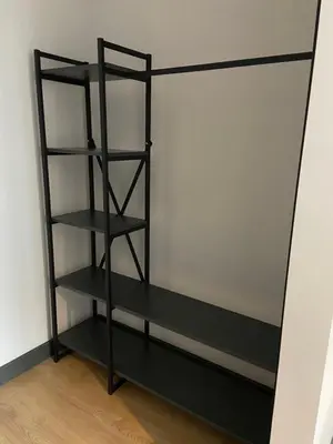 a black book shelf in a room at Luxury Central Fully Equipped 2BR 2BA Apartment by Siena Suites in Istanbul