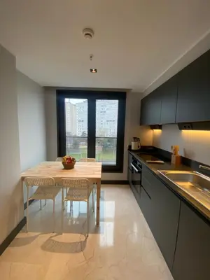 a kitchen with a table and chairs and a window at Luxury Central Fully Equipped 2BR 2BA Apartment by Siena Suites in Istanbul