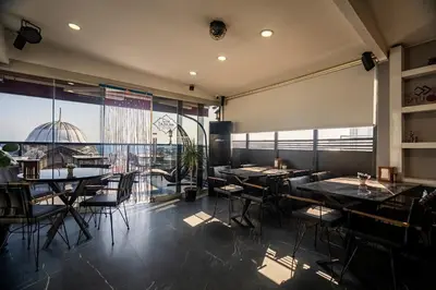 a restaurant with tables and chairs and a large window at York House İstanbul in Istanbul