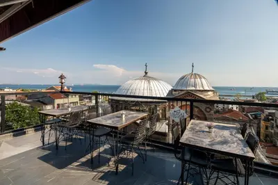 a patio with tables and chairs on a balcony at York House İstanbul in Istanbul