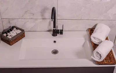 a bathroom sink with towels and a faucet at Ruby Hotel in Istanbul