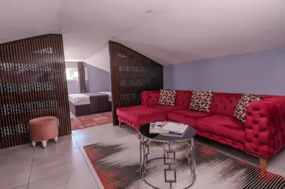 a living room with a red couch and a table at Ruby Hotel in Istanbul
