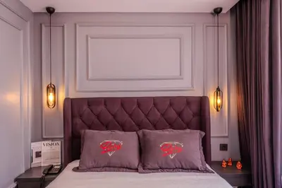 a bedroom with a bed with a headboard and two pillows at Ruby Hotel in Istanbul