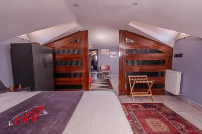 a room with a bed and wooden racks of wine bottles at Ruby Hotel in Istanbul