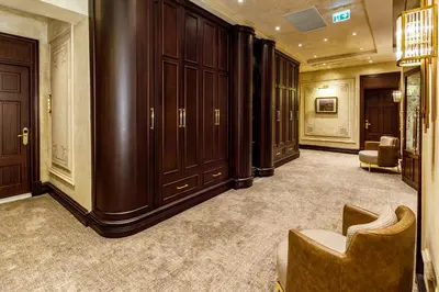 a large room with wooden cabinets and a chair at Cronton Design Hotel in Istanbul