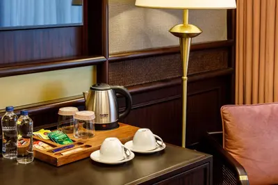 a table with a tea kettle and a lamp on it at Cronton Design Hotel in Istanbul