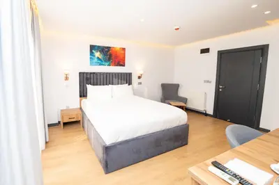 a bedroom with a bed and a desk and a table at Business Life Hotel & SPA Bakırköy in Istanbul