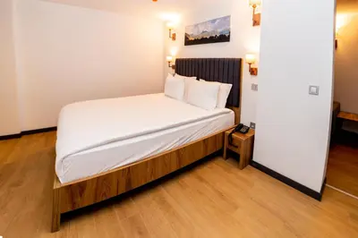 a bedroom with a bed with white sheets and pillows at Business Life Hotel & SPA Bakırköy in Istanbul