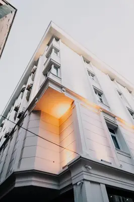 a tall white building with an open window at Business Life Hotel & SPA Bakırköy in Istanbul