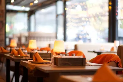 a row of tables in a restaurant with lamps on them at La Vida Old City Hotel in Istanbul