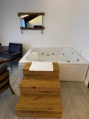 a large bath tub in a room with a chair at Masklavi in Kestel