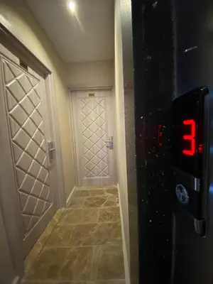 a hallway with a door with a clock on it at Hotel Blue Ottoman in Istanbul