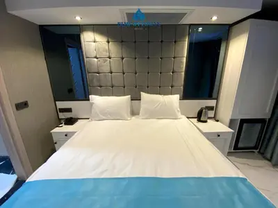 a bedroom with a large bed with a large headboard at Hotel Blue Ottoman in Istanbul