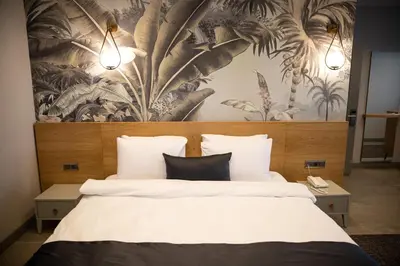 a bedroom with a large bed with a floral wallpaper at Kartepe Panorama in Kartepe