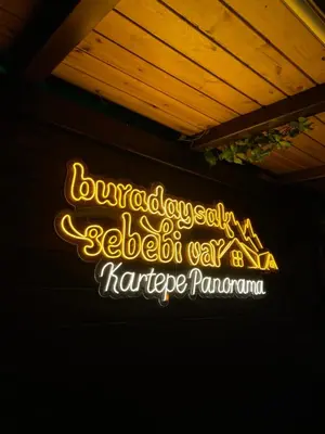 a neon sign on the side of a building at Kartepe Panorama in Kartepe