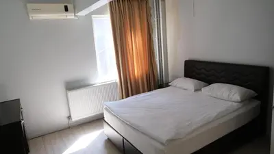 a bedroom with a bed with white sheets and a window at Simon Hotel in Istanbul