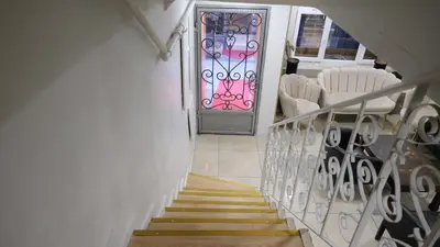 a stairway with a door and a staircase with chairs at Simon Hotel in Istanbul