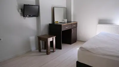 a bedroom with a bed and a dresser with a mirror at Simon Hotel in Istanbul