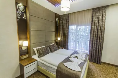 a hotel room with a bed and a window at Taksim Cihangir Fidan Residence Hotel in Istanbul