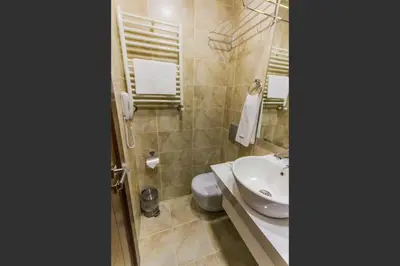 a bathroom with a white sink and a toilet at Taksim Cihangir Fidan Residence Hotel in Istanbul