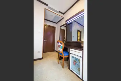 a room with a desk and a chair next to a table at Taksim Cihangir Fidan Residence Hotel in Istanbul