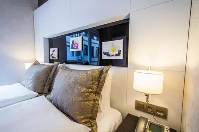 a bedroom with a white bed and a lamp at Taksim Cihangir Fidan Residence Hotel in Istanbul