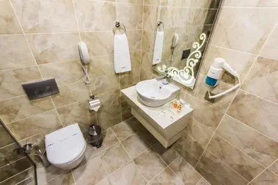 a bathroom with a toilet and a sink and a phone at Taksim Cihangir Fidan Residence Hotel in Istanbul