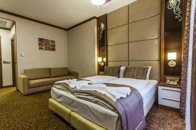 a hotel room with a bed and a couch at Taksim Cihangir Fidan Residence Hotel in Istanbul