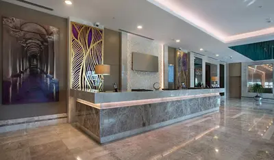 a lobby with a reception desk in a building at Dedeman Bostanci Istanbul Hotel & Convention Center in Istanbul