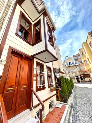 a house with a wooden door on a street at Authentic Turkish Home Suite in Istanbul