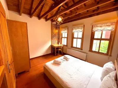 a bedroom with a white bed in a room with windows at Authentic Turkish Home Suite in Istanbul