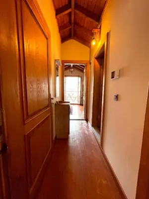 a hallway of a house with a door and wooden floors at Authentic Turkish Home Suite in Istanbul