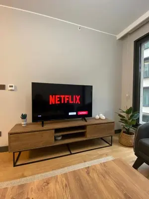 a flat screen tv in a living room at Central Modern Apartment by Siena Suites in Istanbul