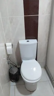 a bathroom with a white toilet and a trash can at Grand İstanbul Airport Hotel in Istanbul