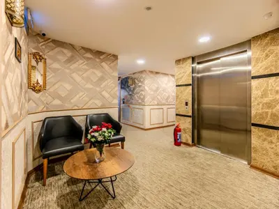 a lobby with two chairs and a table and a door at Sultan Hamit Hotel in Istanbul