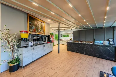 a large kitchen with black cabinets and a counter at Sultan Hamit Hotel in Istanbul