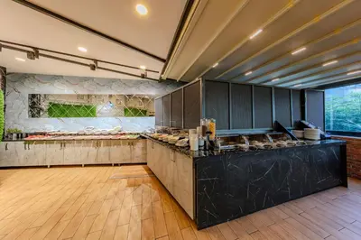 a large kitchen with a counter with food at Sultan Hamit Hotel in Istanbul