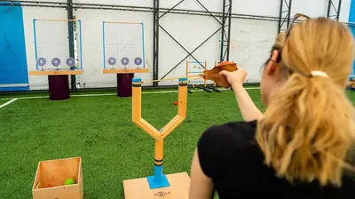 a woman talking on a cell phone while playing a game at Mola İstanbul in Silivri