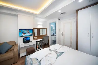 a bedroom with a bed and a living room at Lika Hotel - Standard Double or Twin Room in Istanbul