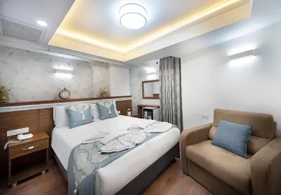 a hotel room with a bed and a chair at Lika Hotel - Eco Double Room - Center Istanbul in Istanbul