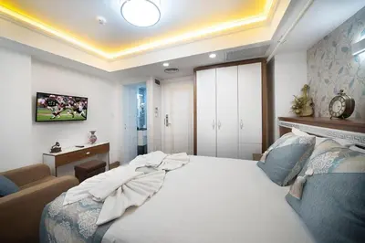 a bedroom with a large white bed in a room at Lika Hotel - Eco Double Room - Center Istanbul in Istanbul