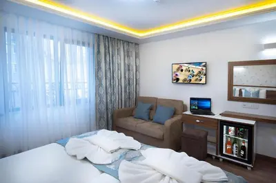 a hotel room with a bed and a couch at Lika Hotel - Superior Double or Twin Room in Istanbul